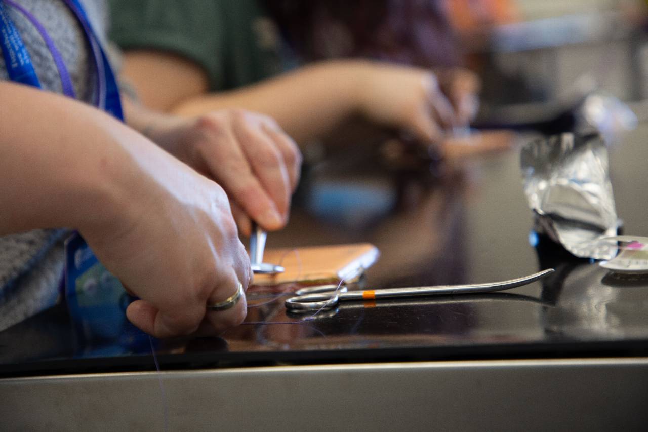 A close up of students' hands as they practice techniques