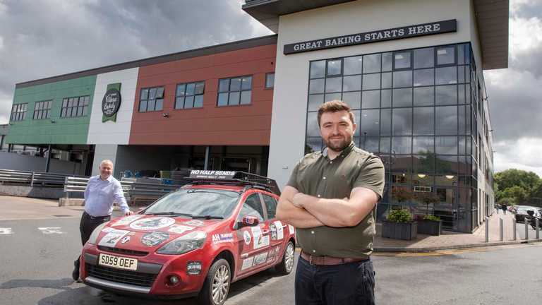 Revving up for the Mongol Rally...George Loftus stands in front of a Renault CLio with Simon Thorpe, CEO Jones Village Bakery behind.