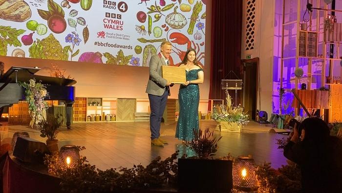 Eleanor Gilbert onstage at the Food and Farming awards receiving her award from Adam Henson