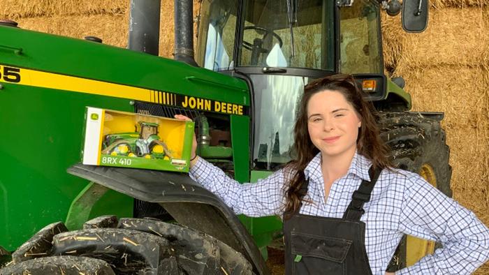 Eleanor Gilbert poses with a tractor
