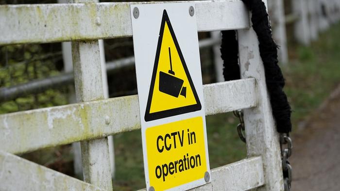 A sign on a farm gate waring of CCTV coverage