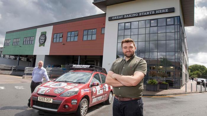 Revving up for the Mongol Rally...George Loftus stands in front of a Renault CLio with Simon Thorpe, CEO Jones Village Bakery behind.