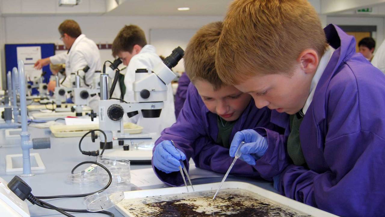 Children testing soil samples in the laboratory at Harper Adams